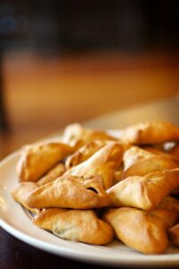 Fatayer platter of mini spinach and cheese pie appetizers from a Teta's Catering.