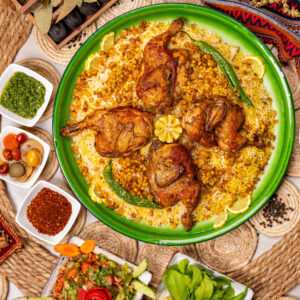 Traditional Mediterranean Makluba catering tray with spiced rice, chicken, and roasted vegetables by Teta's Catering in Toronto